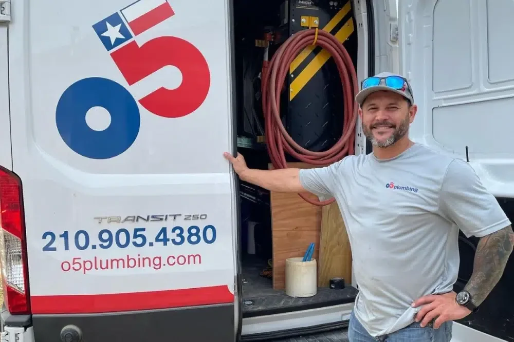 An o5 Plumbing service van and technician on a residential job